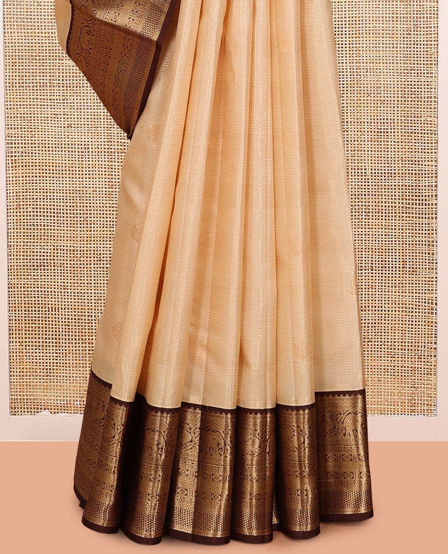 Sandal Vasundhara Silk Saree, Sparsely Sparkled with Zari Checks and Mayil Buttas, a Contrast Border of Thilakam Mokku, Banaras, Neli, Mayil, Yaanai, Mayil Kann, and Ara Maadam Designs, Grand Pallu, and a Contrast Blouse