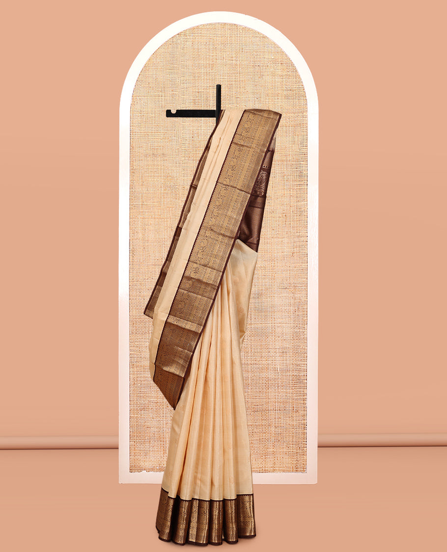 Sandal Vasundhara Silk Saree, Sparsely Sparkled with Zari Checks and Mayil Buttas, a Contrast Border of Thilakam Mokku, Banaras, Neli, Mayil, Yaanai, Mayil Kann, and Ara Maadam Designs, Grand Pallu, and a Contrast Blouse