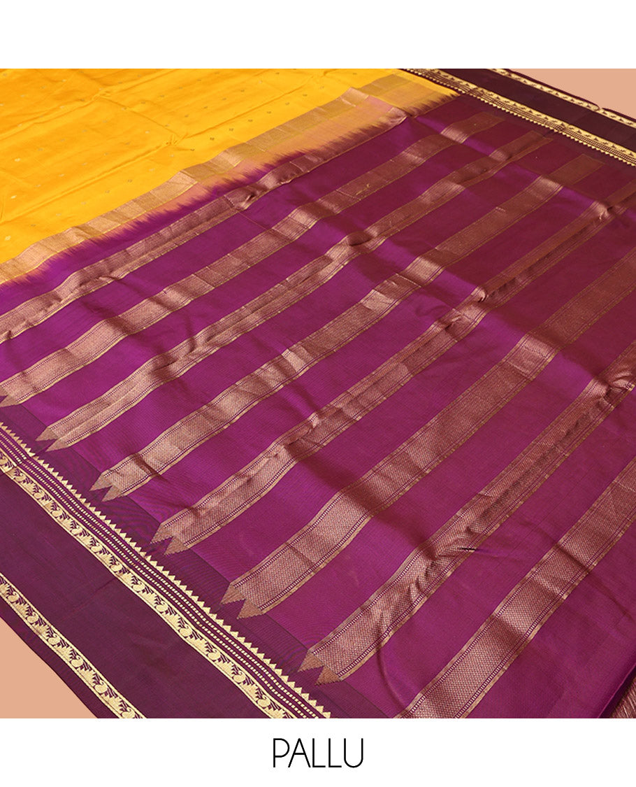 Yellow Vasundhara Silk Saree, Subtly Sparkled with Zari Buttas All Over Its Body, Complemented by a Contrast Rettai Pettu Temple Border of Rekku, Muthu, Manga, and Thazampoo Rekku Designs, Grand Pallu, and Paired with a Contrast Blouse