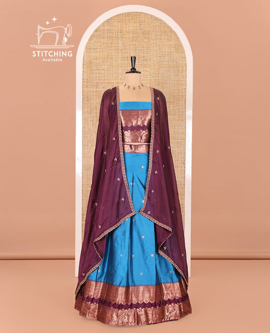 Blue-Purple Semi-Banarasi Half-Saree Mesmerized with Zari Buttas on Its Skirt, Complemented by a Contrast Traditional Zari Temple Rettai Pettu Border, Paired with a Matching Blouse, and a Satin Georgette Embroidered Scallop Dhavani