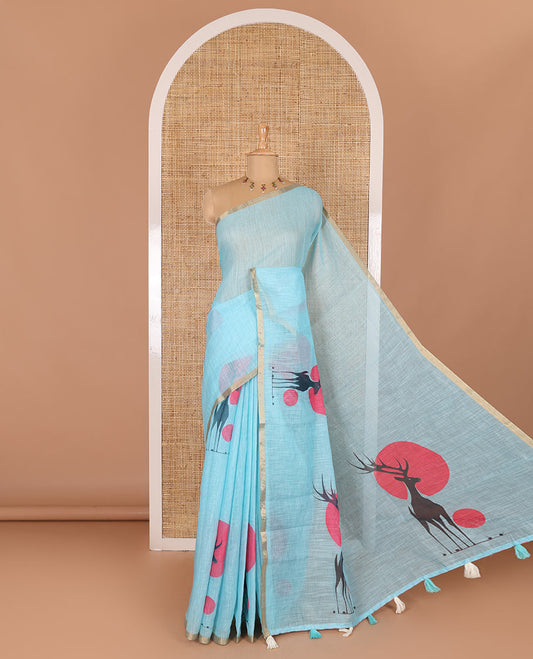 Blue sun and deer silhouette printed linen cotton saree, gold zari piping border, printed pallu, and a matching stripes printed blouse