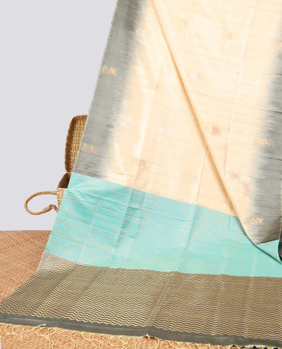 Cream floral buttas soft silk saree with contrast floral border & zig zag striped zari design pallu