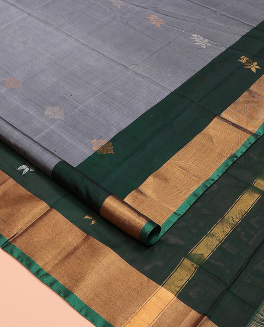 Grey Uppada Silk Saree, Subtly Sparkled with Buttas All Over Its Body, Complemented by a Contrast Bavanji Border of Zari Buttas, Pallu Steeped with Zari Buttas, and Paired with a Contrast Blouse