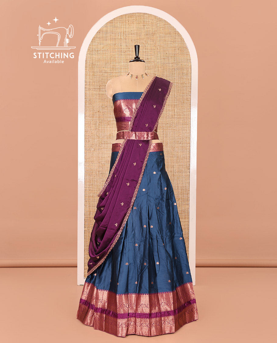 Blue and Purple Semi-Banarasi Half-Saree Featuring Zari Buttas Skirt, Complemented by Contrast Rettai Pettu, Traditional Border of Floral Creeper Designs, Paired with a Matching Blouse, and a Satin Georgette Embroidered Scallop Dhavani