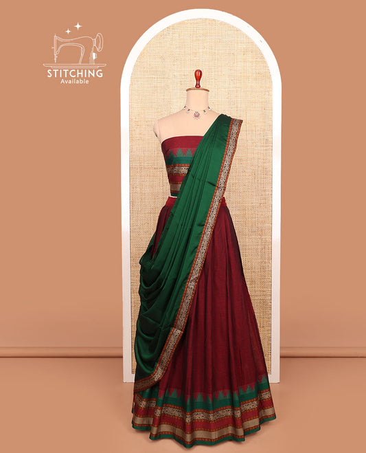 Maroon plain cotton half-saree with contrast traditional bordered skirt, matching blouse, and a contrast traditional bordered dhavani