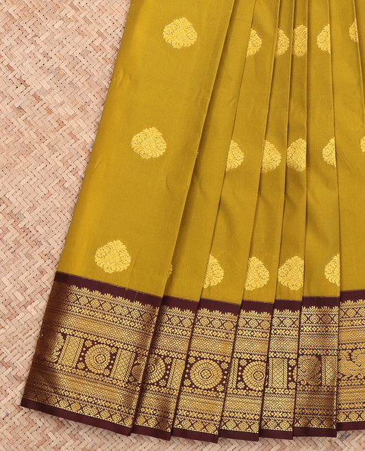 Green Budget Silk Saree, Sparsely Woven with Buttas All Over Its Body, Complemented by a Contrast Traditional Zari Border of Peacock-Chakram Designs, Pallu of Jaal Zari Designs, and Paired with a Contrast Blouse