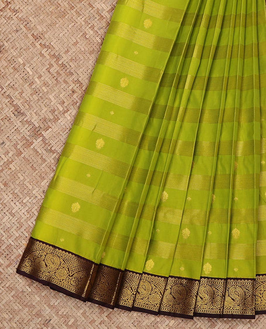 Leaf Green Budget Silk Saree, Gleamed Up with Zari Buttas and Zari Stripes on Its Body, Complemented by a Contrast Traditional Zari Border of Peacock Designs, Grand Pallu, and Paired with a Contrast Blouse