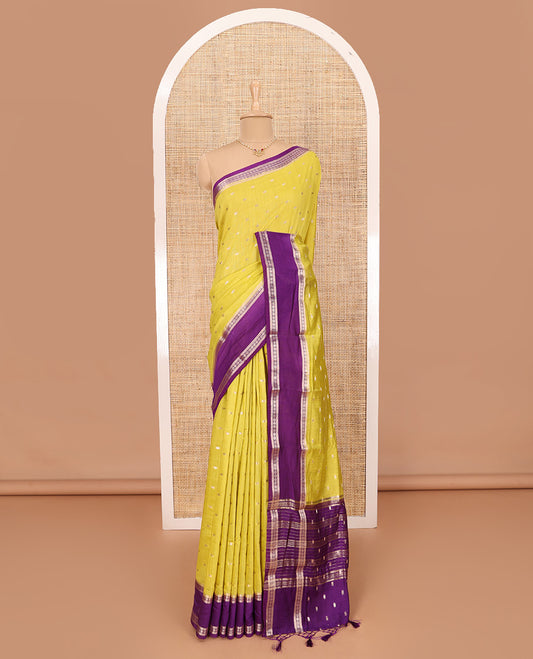 Elegant Yellow Assam Silk Saree Features Zari Buttas All Over the Body, Complemented by Contrast Traditional Zari Design Border, Pallu Elevated with Zari Stripes, and Paired with a Contrast Blouse