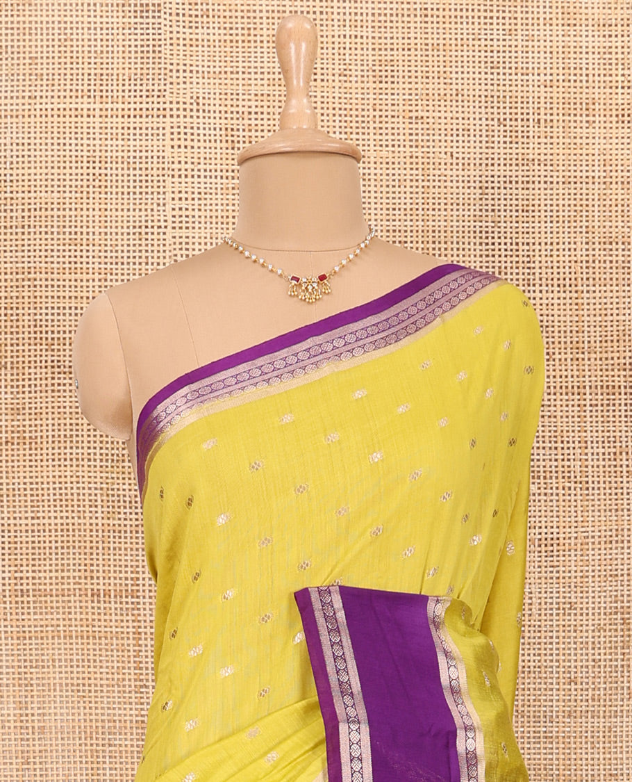 Elegant Yellow Assam Silk Saree Features Zari Buttas All Over the Body, Complemented by Contrast Traditional Zari Design Border, Pallu Elevated with Zari Stripes, and Paired with a Contrast Blouse