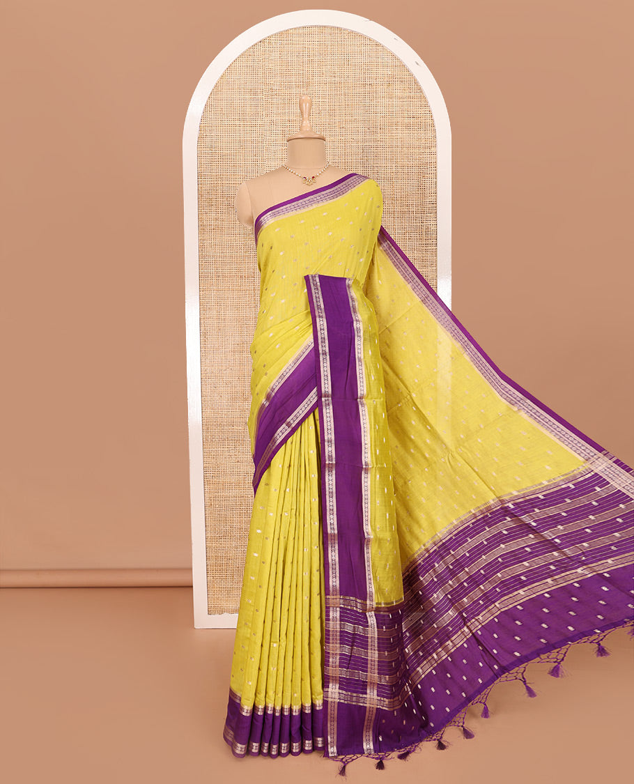 Elegant Yellow Assam Silk Saree Features Zari Buttas All Over the Body, Complemented by Contrast Traditional Zari Design Border, Pallu Elevated with Zari Stripes, and Paired with a Contrast Blouse