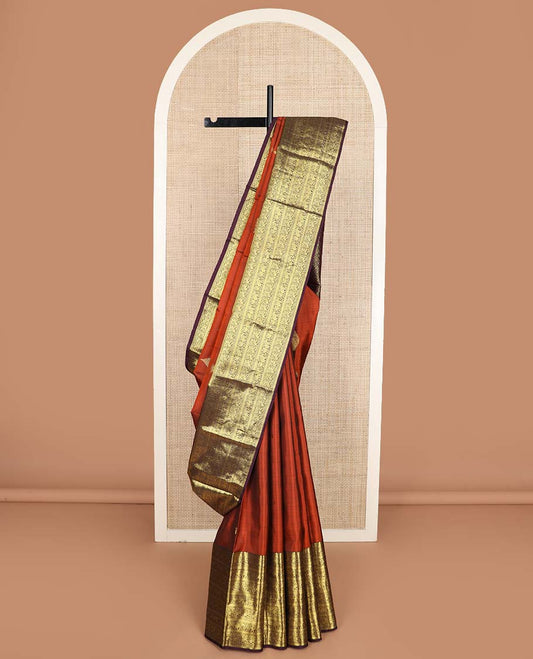 Orange manga buttas Kanchipuram silk saree, contrast border of thilakam mokku, kathir, kuthirai, and yaanai designs, and pallu steeped with manga motifs