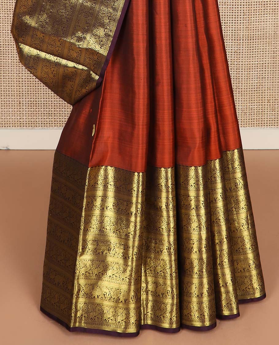 Orange manga buttas Kanchipuram silk saree, contrast border of thilakam mokku, kathir, kuthirai, and yaanai designs, and pallu steeped with manga motifs