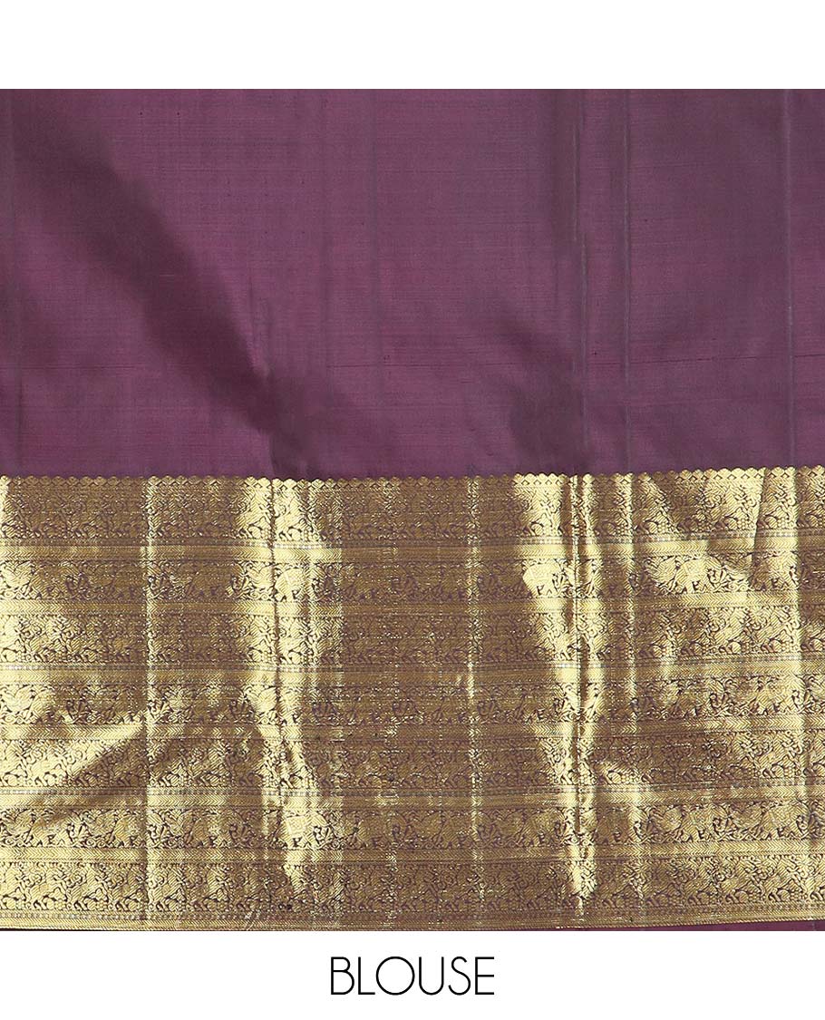 Orange manga buttas Kanchipuram silk saree, contrast border of thilakam mokku, kathir, kuthirai, and yaanai designs, and pallu steeped with manga motifs