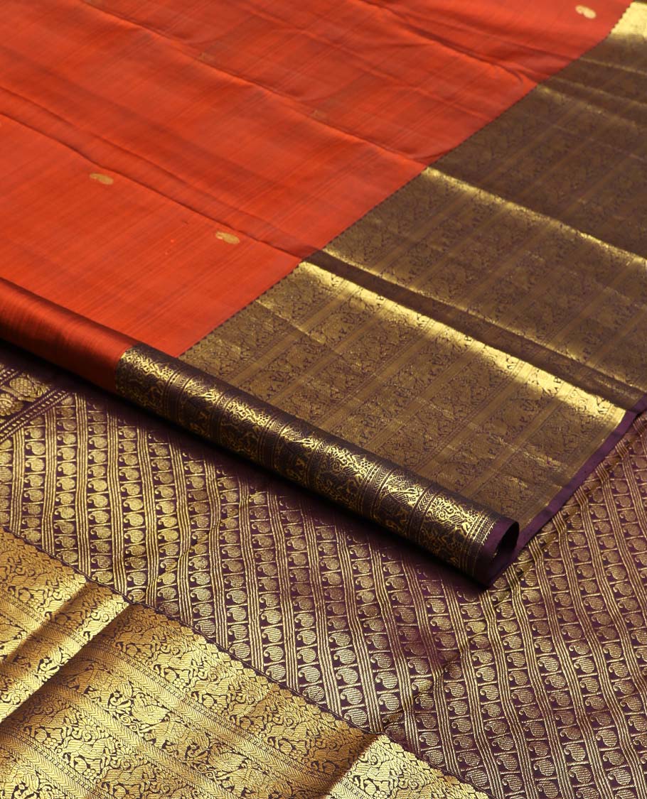 Orange manga buttas Kanchipuram silk saree, contrast border of thilakam mokku, kathir, kuthirai, and yaanai designs, and pallu steeped with manga motifs