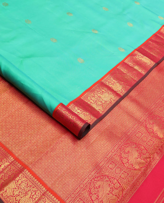 Turquoise mayil buttas silk saree, contrast border of thilakam mokku, muthu, and mayil designs, and jaal pallu