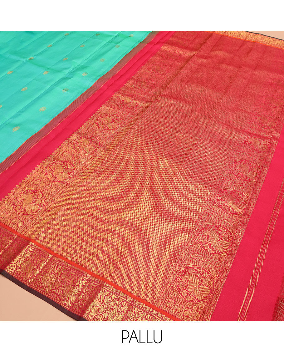 Turquoise mayil buttas silk saree, contrast border of thilakam mokku, muthu, and mayil designs, and jaal pallu