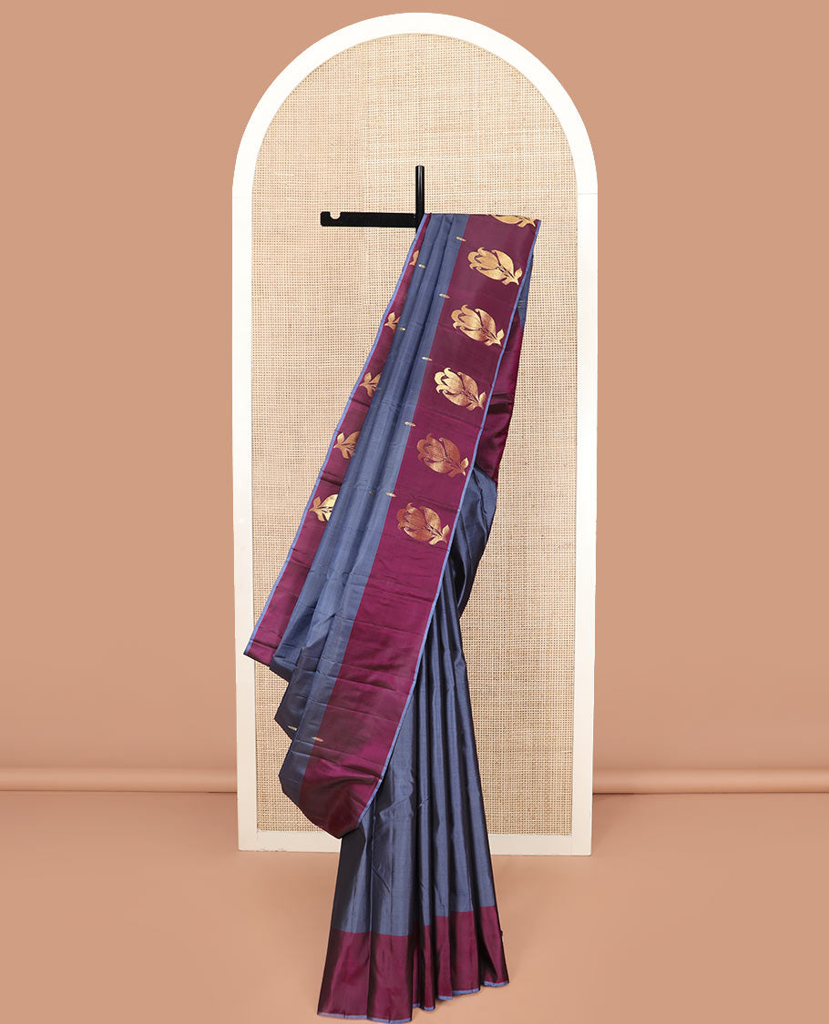 Grey Kanchipuram Silk Saree Highlighted with Zari Buttas, a Contrast Border of Floral Designs, a Subtle Woven Pallu of Floral Designs, and a Contrast Plain Blouse