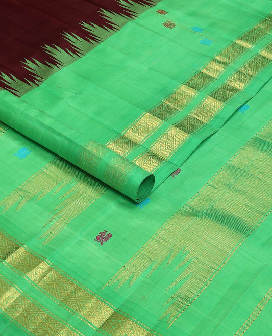 Maroon kancheepuram silk saree with mayil zari buttas, contrast one-sided thazampoo reku border of mayil, muthu & jaal design & pallu of mayil & pillaiyar mokku designs