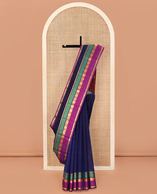 Blue Kanchipuram Silk Saree, Subtly Sparkled with Stripes All Over Its Body, Complemented by a Contrast Border of Manga, Banaras, Poun, and Rettai Neli Designs, Pallu of Zari Stripes, and Paired with a Contrast Blouse