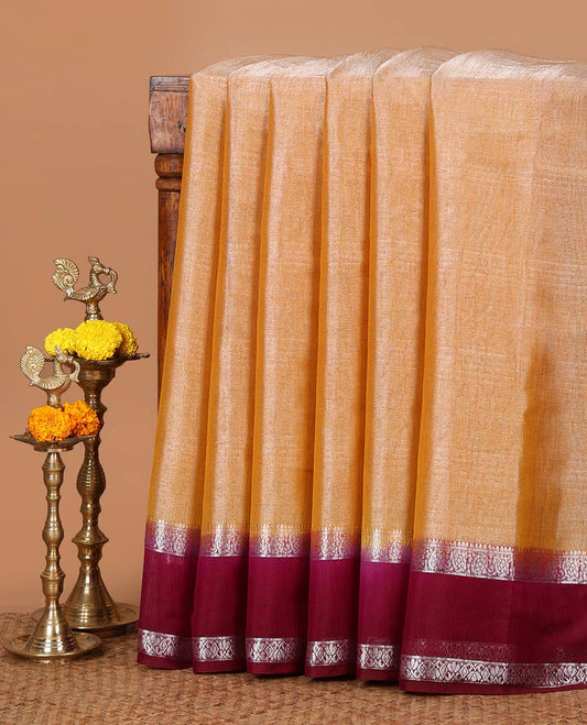 Peach plain design Tissue silk saree, contrast traditional zari border of bentex design & lined pallu with tassels
