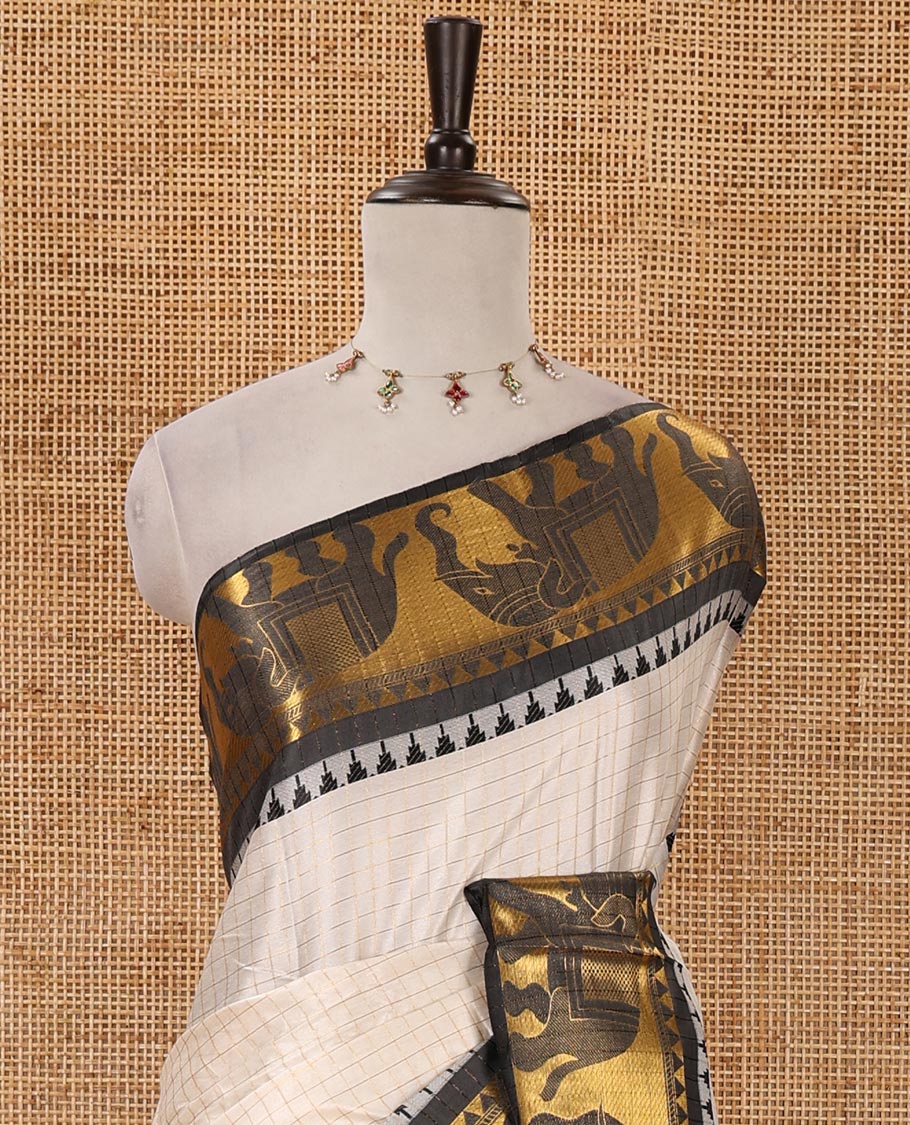 White checked semi-tafeta saree, contrast temple zari elephant motifs black color border, zari-rich pallu & contrast checked zari border blouse