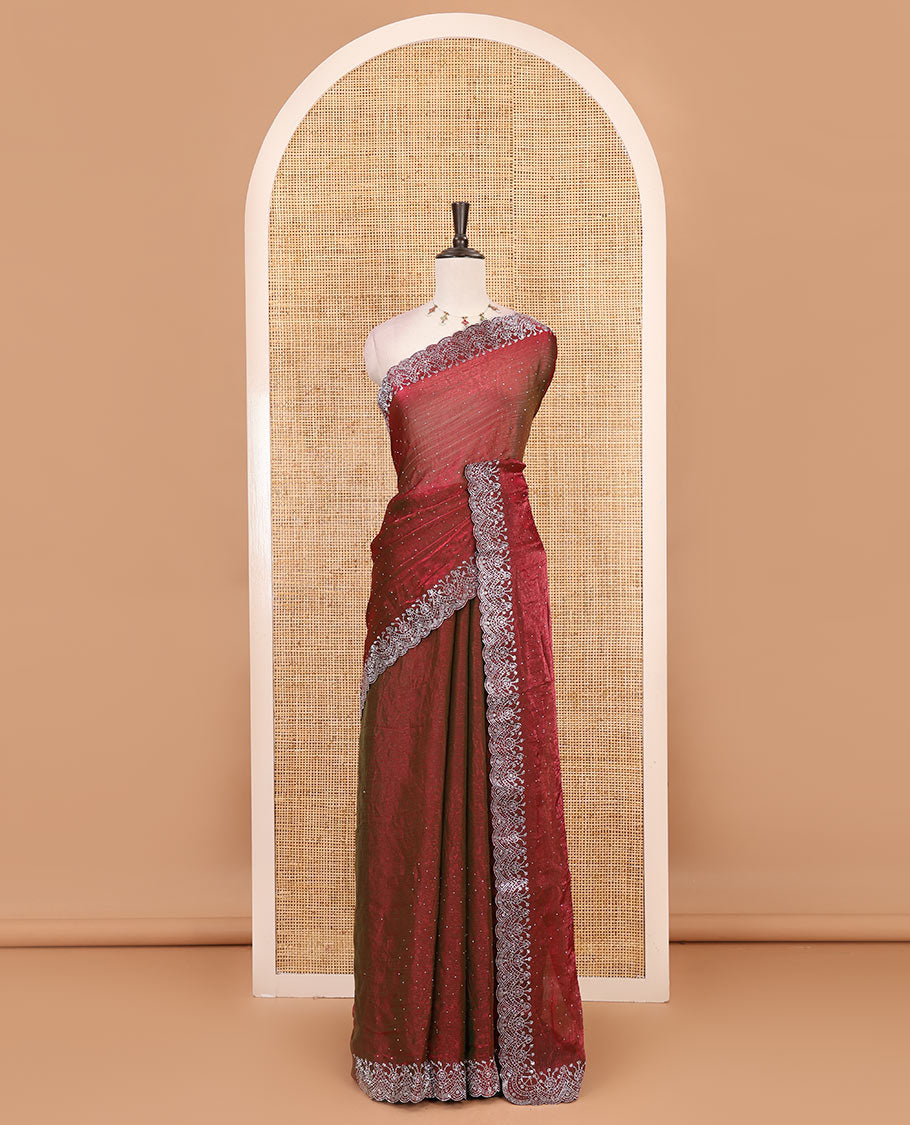 Maroon Swarovski crystal stone embedded fendy chiffon saree, scallop border accentuated with floral and scallop design in Swarovski stones