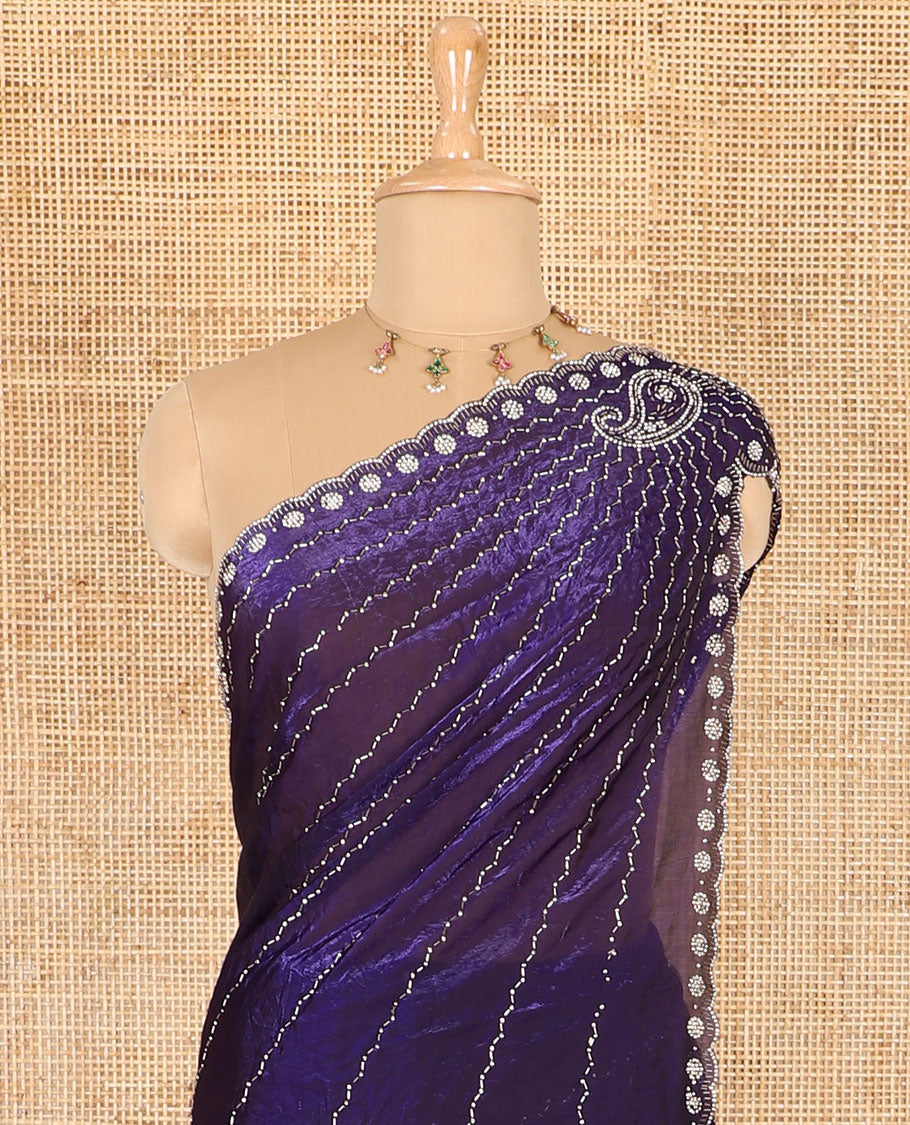 Violet micro-stone work fendy chiffon saree with paisley stone work on its shoulder, a scallop stone work border, a butterfly style pallu, and a matching stone work blouse