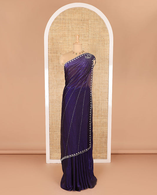 Violet micro-stone work fendy chiffon saree with paisley stone work on its shoulder, a scallop stone work border, a butterfly style pallu, and a matching stone work blouse