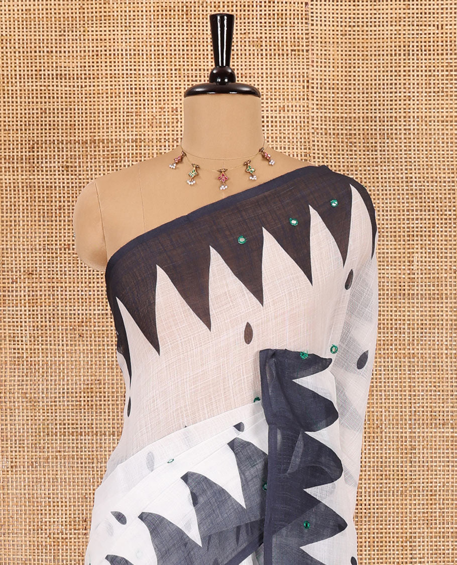 White thilakam buttas and mirror work khadi mul cotton saree, contrast temple border, striped and buttas pallu, and a contrast printed blouse