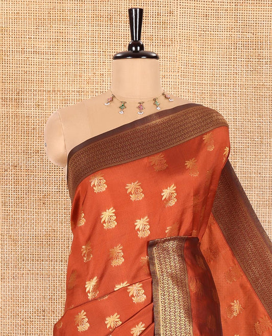 Rust Orange Kanchi Silk Saree Graced with Gold Zari Buttas Woven All Over Its Body, Complemented by Contrast Traditional Zari Design Border, Pallu Majestically Detailed with Intricate Zari Designs, and Paired with a Contrast Blouse