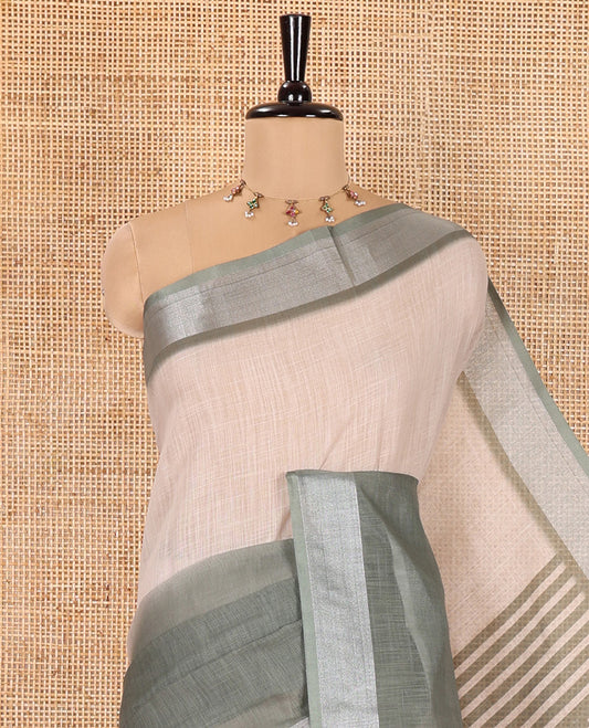 Cream and Green Plain Linen Cotton Saree, Subtly Ombre-Style Dual-Color Dye on Its Body, Subtle Bavanji Zari Border, Pallu Features Rangoli-Style Patterns Print, and Paired with a Polka Dots Printed Blouse