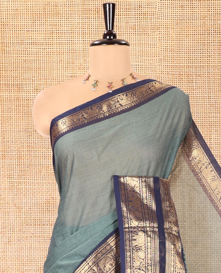 Green Plain Chettinad Cotton Saree, Complemented by a Contrast Traditional Zari Border of Peacock and Elephant Designs, Subtly Striped Pallu, and Paired with a Matching Blouse