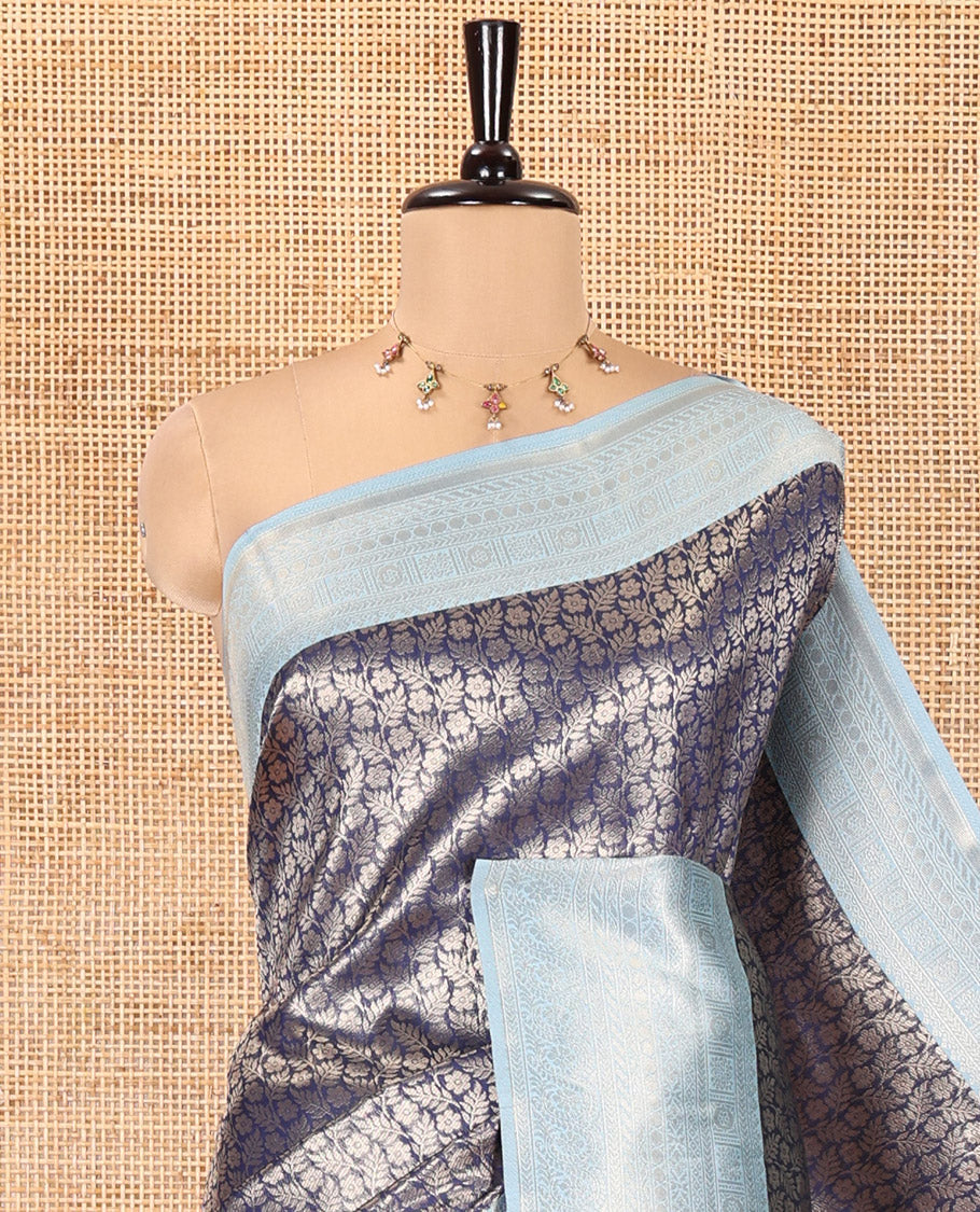 Navy Blue Kanchi Silk Saree, Gleamed Up with Floral-Leaf Jacquard Design on Its Body, Complemented by a Contrast Traditional Zari Design Border, Intricately Designed Pallu, and Paired with a Contrast Blouse