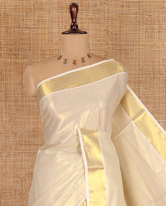 Gold Plain Kerala Tissue Saree, a Gleaming Zari Border, a Self-Pallu, and a Matching Blouse