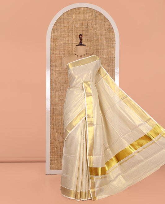 Gold Plain Kerala Tissue Saree, a Gleaming Zari Border, a Self-Pallu, and a Matching Blouse
