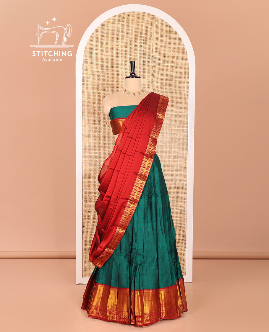 Green and Red Mercerised Cotton Half-Saree Featuring Plain Skirt, Adorned with a Contrast Peacock Eye-Rudraksham Motifs Woven Zari Border, Paired with a Matching Blouse, and Contrast Syska Georgette Dhavani with Zari Border