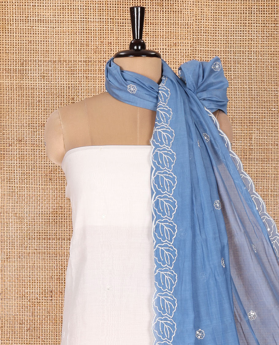 Cream and Blue Mul Chanderi Material Chudidar Set, Delicately Designed with Floral Embroidery On Its Top, A Plain Santoon Bottom, and Comes with a Contrast Scallop Floral Embroidered Dupatta