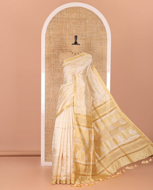 Gold geometric batik printed banana pith saree, printed piping border, paisley motifs steeped pallu, and a matching blouse