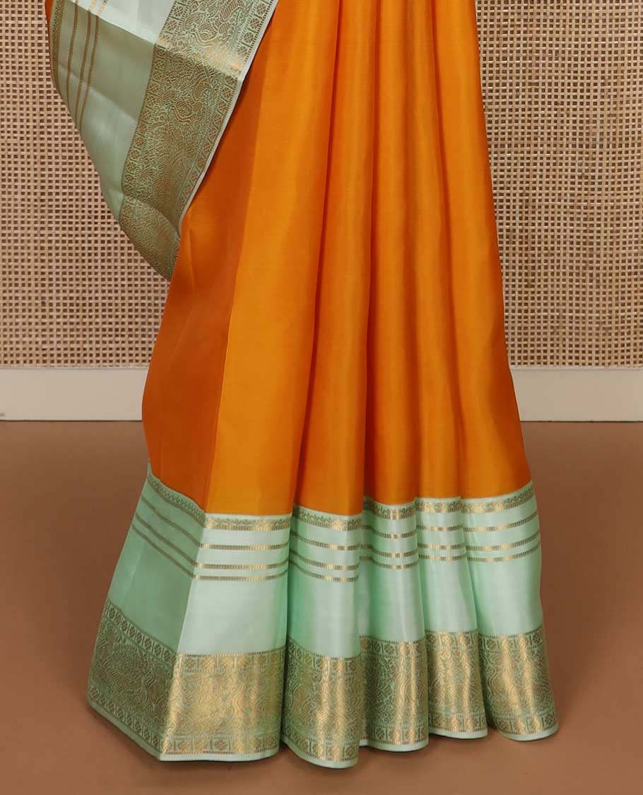Orange zari buttas Vasundhara silk mix saree, contrast rettai pettu border of muthu, kamalam and annam designs, and intricate pallu