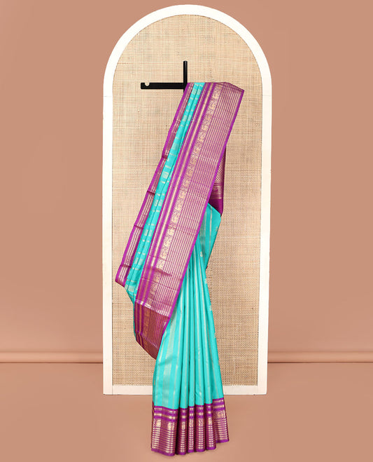 Blue Vasundhara Silk Saree, Embellished with Zari Designs All Over Its Body, Complemented by a Contrast Korvai Border of Thilakam Mokku, Muthu, and Yaali Designs, Grand Jaal Pallu, and Paired with a Contrast Blouse