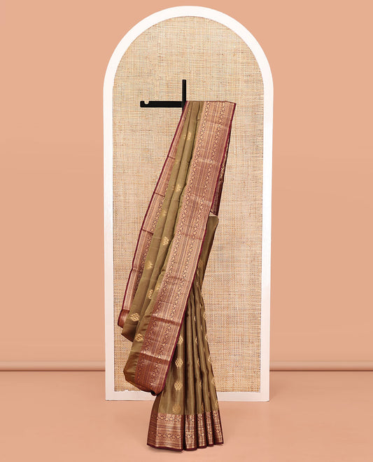 Light Brown Vasundhara Lite Silk Mix Saree, Ornamented With Zari Buttas All Over Its Body, Complemented by Contrast Border of Thilakam Mokku, Kodi Visiry, Neli, Diamond, and Paiyadi Kattam, Grand Pallu and Paired with a Contrast Blouse