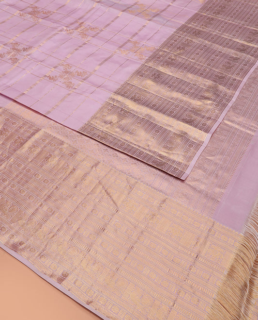 Pink Vasundhara Silk Saree Elevated with Zari Designs All Over Its Body, Complemented by Zari Border of Rekku, Kathir, Star Vanki, Iruthalai Pakshi, and Mayil Designs, a Grand Pallu, and Paired with a Matching Blouse
