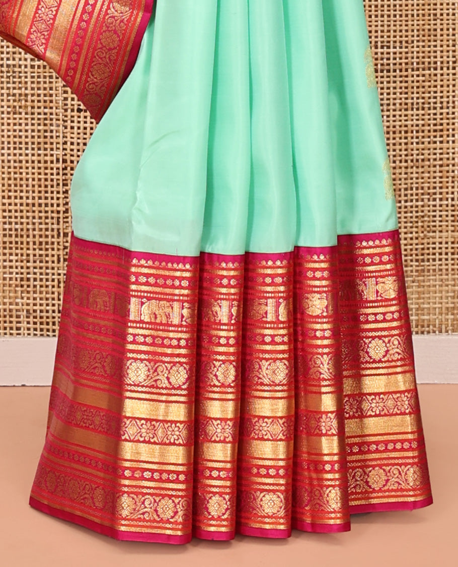 Turquoise Vasundhara Silk Saree, Embellished with Zari Buttas All Over Its Body, Complemented by a Contrast Border of Thilakam Mokku, Yaanai, Iruthalai Pakshi, and Kodi Visiry Designs, Grand Pallu, and Paired with a Contrast Blouse