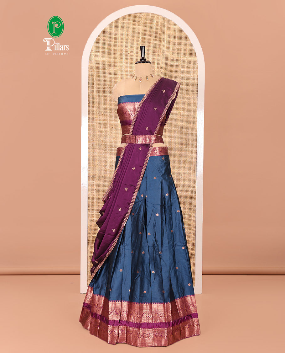 Blue and Purple Semi-Banarasi Half-Saree Featuring Zari Buttas Skirt, Complemented by Contrast Rettai Pettu, Traditional Border of Floral Creeper Designs, Paired with a Matching Blouse, and a Satin Georgette Embroidered Scallop Dhavani