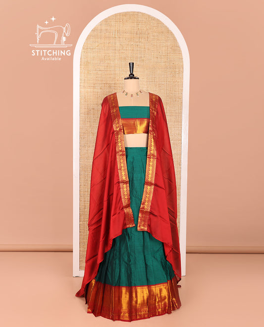 Green and Red Mercerised Cotton Half-Saree Featuring Plain Skirt, Adorned with a Contrast Peacock Eye-Rudraksham Motifs Woven Zari Border, Paired with a Matching Blouse, and Contrast Syska Georgette Dhavani with Zari Border
