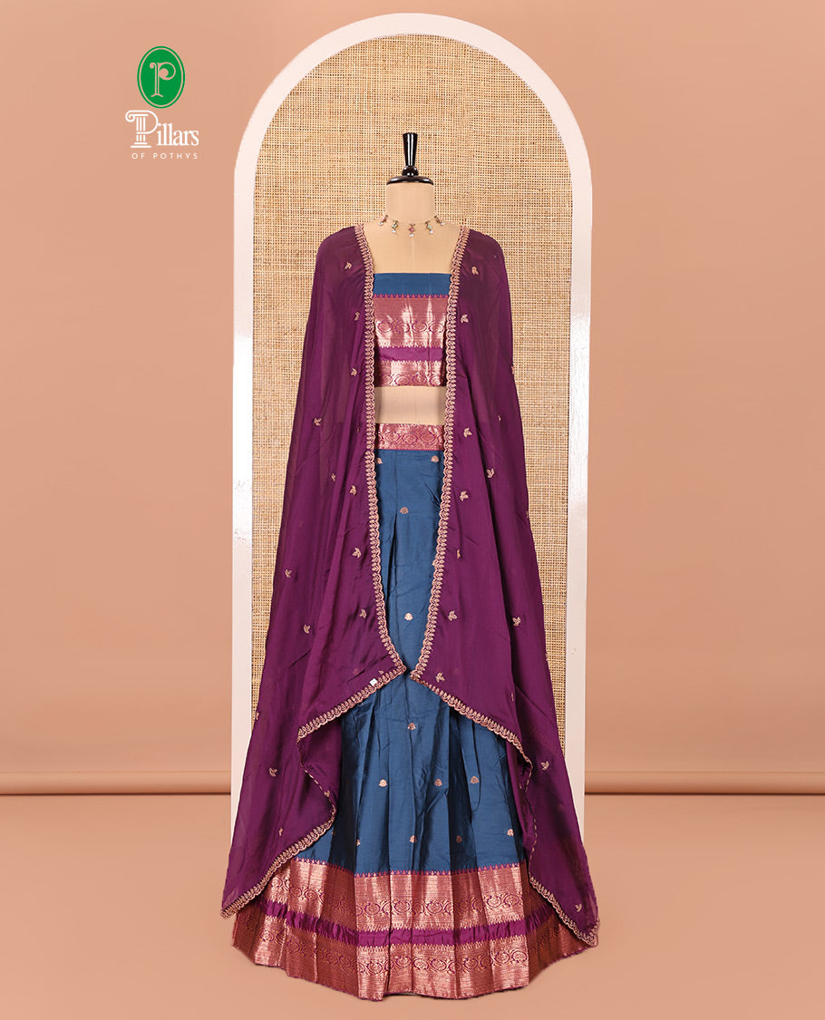 Blue and Purple Semi-Banarasi Half-Saree Featuring Zari Buttas Skirt, Complemented by Contrast Rettai Pettu, Traditional Border of Floral Creeper Designs, Paired with a Matching Blouse, and a Satin Georgette Embroidered Scallop Dhavani
