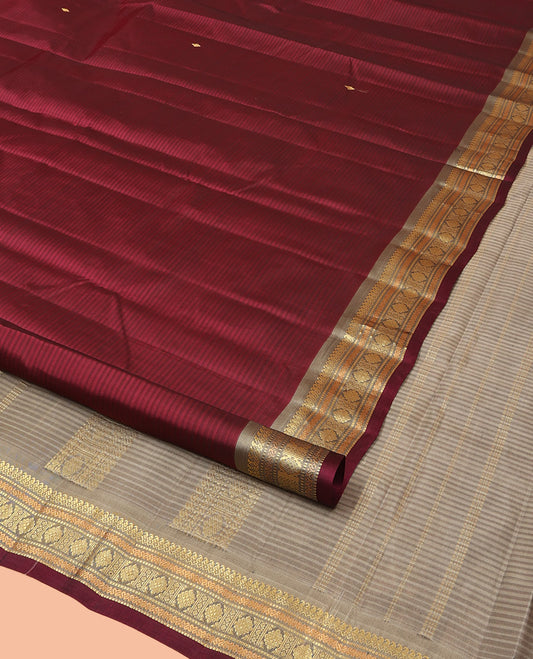 Maroon Kanchipuram Silk Saree Beautified with Vazhaipoo Stripes and Zari Buttas, Complemented by Contrast Border Featuring Manga Mokku, Muthu, Greek Key, and Laddu Kamalam Designs, Sparsely Zari Woven Pallu, and Paired with a Contrast Blouse