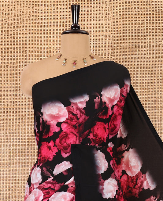 Borderless black and rani pink floral printed satin crepe saree, floral printed pallu, and a matching floral printed blouse