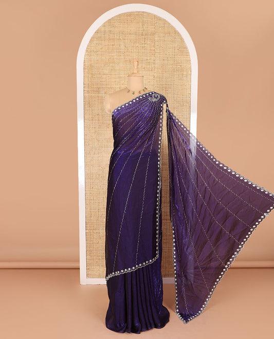 Violet micro-stone work fendy chiffon saree with paisley stone work on its shoulder, a scallop stone work border, a butterfly style pallu, and a matching stone work blouse