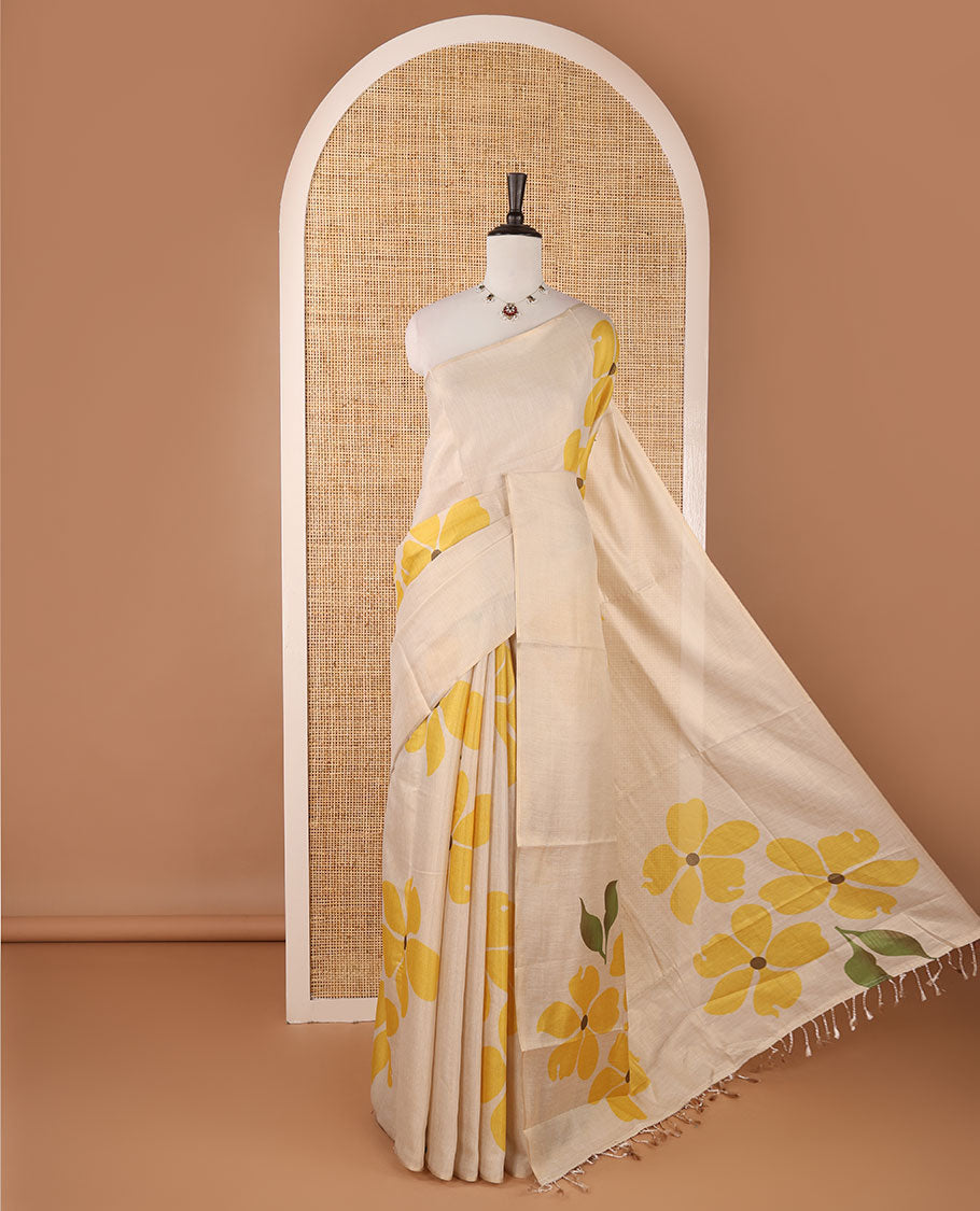 Borderless cream printed onam tissue silk saree features yellow color five-petal flower & leaf motifs print, matching floral print blouse